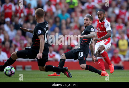 Arsenal's Theo Walcott scores his side's first goal of the game during the Premier League match at the Emirates Stadium, London. Stock Photo