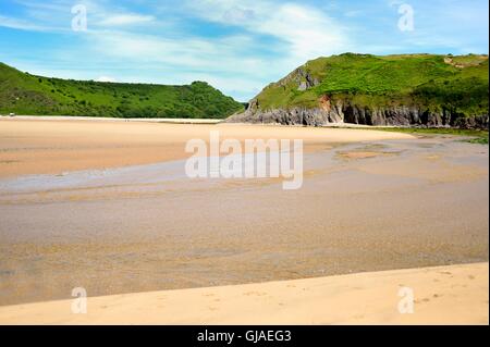 Golden sand exposed at low tide at Three cliffs bay Stock Photo