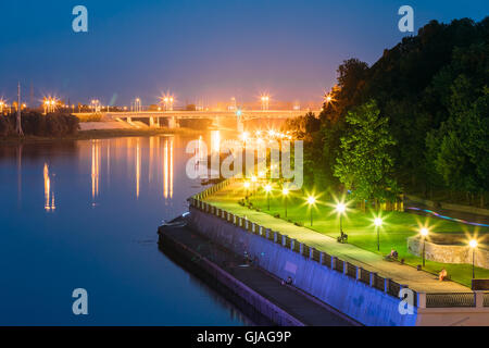 The Scenic Summer Evening View Of Sozh River, Illuminated Embankment And Ancient Greenwood Park In Gomel, Homiel, Belarus. Blue Stock Photo