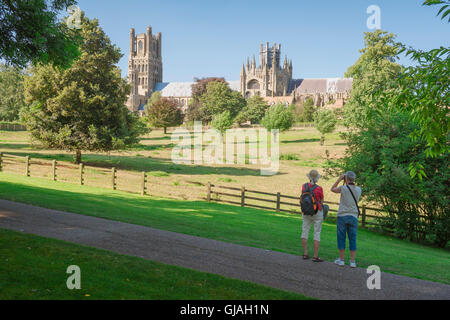 England countryside UK, view in summer of a mature couple looking towards the cathedral in Ely and its surrounding countryside, Cambridgeshire, UK. Stock Photo
