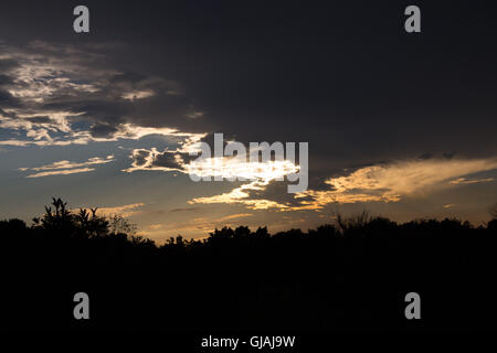 Evening sunlight filtering through clouds, creating a silver lining Stock Photo