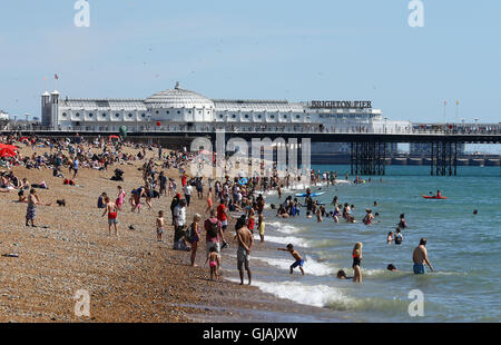 People enjoy the warm weather on the beach in Brighton, East Sussex, as Britons are set to bask in a three-day sunny spell as the mercury rises well above average for the time of year. Stock Photo