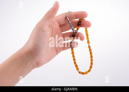 Hand holding a tespih on a white background Stock Photo