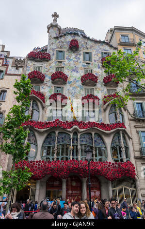 Façade of Casa Batlló by Antoni Gaudí. Balconies decorated with red roses for Sant Jordi's day (23 April). Barcelona, Spain. Stock Photo