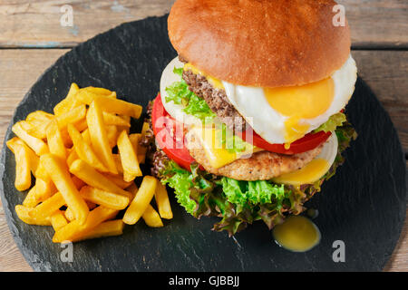 hamburger meat cutlet egg cheese french fries Stock Photo