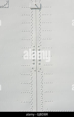 Aluminum fuselage and rivets on old airplane Stock Photo