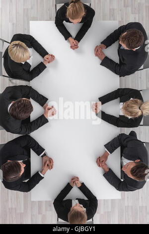 Diverse business people sitting around the table on a meeting Stock Photo