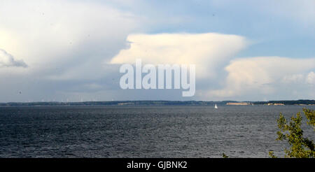 A cumulonimbus cloud with its anvil shape tries to establish on a warm autumn day, but fails. Stock Photo