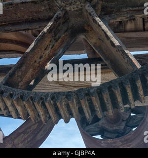 Time and weather has found a way to start the rusting process on this toothed gear. Stock Photo