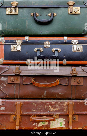 Four old and worn leather suitcases Stock Photo