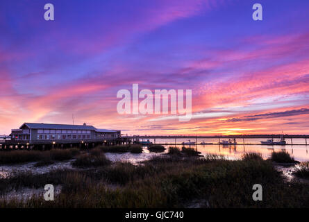 Sunset over the marsh and Lattitude 31 restaurant on Jekyll Island in Georgia Stock Photo