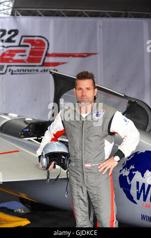 Hannes Arch (AUT) standing next to his Zivko Aeronautics Edge 540 racing plane in the hanger shortly before the last day of racing at the Red Bull Air Race, Ascot, United Kingdom.  The Red Bull Air Race features the world’s best race pilots in a pure motorsport competition that combines speed, precision and skill. Using the fastest, most agile, lightweight racing planes, pilots hit speeds of 370kmh while enduring forces of up to 10G as they navigate a low-level slalom track marked by 25-meter-high, air-filled pylons.  Arch came third in the final race winning bronze. Matt Hall (AUS) won taking Stock Photo