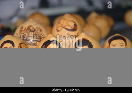 Liaocheng, Liaocheng, China. 15th Aug, 2016. Liaocheng,?CHINA?-?August?14?2016:?(EDITORIAL?USE?ONLY.?CHINA?OUT)?.Portraits of Olympic Gold Medalists on the surface of egg-shaped gourds made by Chinese folk artist Ji Zhenshan.Ji Zhenshan, a folk artist living in east ChinaÂ¡Â¯s Shandong Province, paints portraits of Olympic gold medalists on the surface of egg-shaped gourds celebrating Chinese athletesÂ¡Â¯ achievements at the on-going 2016 Rio Olympic Games. Ji has painted the portraits of Chinese champions including swimmer Sun Yang, diver Wu Minxia and pistol shooter Zhang Mengxue. Now he Stock Photo