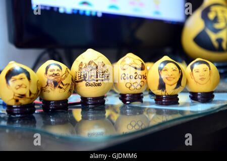 Liaocheng, Liaocheng, China. 15th Aug, 2016. Liaocheng,?CHINA?-?August?14?2016:?(EDITORIAL?USE?ONLY.?CHINA?OUT)?.Portraits of Olympic Gold Medalists on the surface of egg-shaped gourds made by Chinese folk artist Ji Zhenshan.Ji Zhenshan, a folk artist living in east ChinaÂ¡Â¯s Shandong Province, paints portraits of Olympic gold medalists on the surface of egg-shaped gourds celebrating Chinese athletesÂ¡Â¯ achievements at the on-going 2016 Rio Olympic Games. Ji has painted the portraits of Chinese champions including swimmer Sun Yang, diver Wu Minxia and pistol shooter Zhang Mengxue. Now he Stock Photo