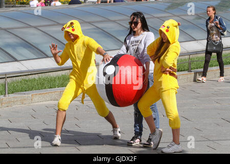 Kyiv, Ukraine. 15th Aug, 2016. Young people wearing Pokemon costumes hunt the passers-by exactly the way people hunt Pokemons playing the ''Pokemon Go'' game with their smartphones and tablets. Launched at the beginning of July by the US company Niantic, the mobile phone game 'Pokemon Go' has found a real success worldwide and already have generated more than 160 US million dollars. © Sergii Kharchenko/ZUMA Wire/Alamy Live News Stock Photo