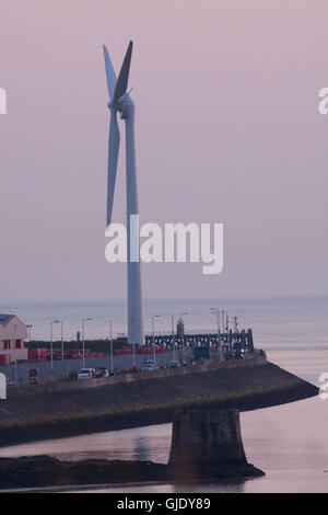 Heysham, Lancashire, United Kingdom. 15th Aug, 2016. Photographed in the late evening sun is the new 77m high wind turbine that has been errected on the North Quay at Heysham Harbour which was completed today. The Turbine which is being errected by Peel Energy Credit:  David Billinge/Alamy Live News Stock Photo