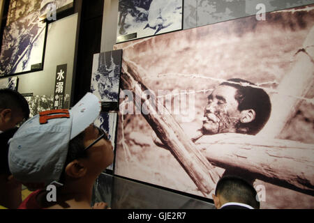 Nanjing, Nanjing, China. 16th Aug, 2016. Nanjing, CHINA - August 6 2016: (EDITORIAL USE ONLY. CHINA OUT) Visitors look at the files and ironclads of Japanese invaders' cruel massacre at Nanjing Massacre VictimsÂ¡Â¯ Memorial Hall. Tomomi Inada, who was appointed as Japanese defense minister, denied the existence of killing competition during the Nanjing Massacre that left an estimated 300,000 people dead in interviews with local media on August 4, 2016. China recently slammed the new Japanese ministerÂ¡Â¯s fault of denying the history and said that Japan should face up to the fact. (Credit I Stock Photo