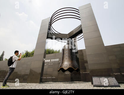 Nanjing, Nanjing, China. 16th Aug, 2016. Nanjing, CHINA - August 6 2016: (EDITORIAL USE ONLY. CHINA OUT) Visitors look at the files and ironclads of Japanese invaders' cruel massacre at Nanjing Massacre VictimsÂ¡Â¯ Memorial Hall. Tomomi Inada, who was appointed as Japanese defense minister, denied the existence of killing competition during the Nanjing Massacre that left an estimated 300,000 people dead in interviews with local media on August 4, 2016. China recently slammed the new Japanese ministerÂ¡Â¯s fault of denying the history and said that Japan should face up to the fact. (Credit I Stock Photo