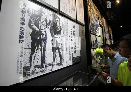 Nanjing, Nanjing, China. 16th Aug, 2016. Nanjing, CHINA - August 6 2016: (EDITORIAL USE ONLY. CHINA OUT) Visitors look at the files and ironclads of Japanese invaders' cruel massacre at Nanjing Massacre VictimsÂ¡Â¯ Memorial Hall. Tomomi Inada, who was appointed as Japanese defense minister, denied the existence of killing competition during the Nanjing Massacre that left an estimated 300,000 people dead in interviews with local media on August 4, 2016. China recently slammed the new Japanese ministerÂ¡Â¯s fault of denying the history and said that Japan should face up to the fact. (Credit I Stock Photo