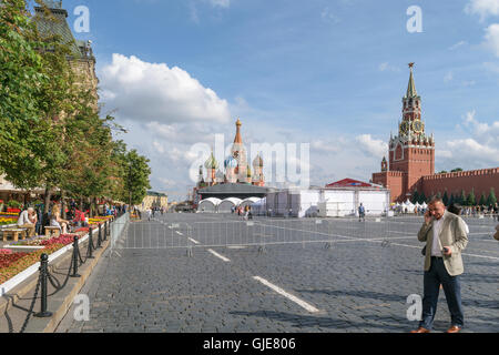 Moscow, Russia - July 07, 2016: A man talking on a cell phone, standing in Red Square near the Kremlin Stock Photo