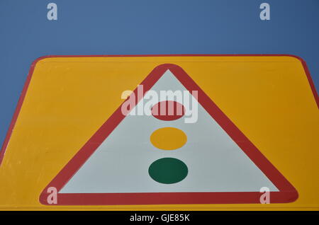 Traffic Light on Yellow Sign Board Stock Photo