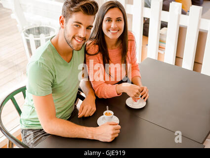 Youg couple at the local coffee shop drinking a coffee Stock Photo