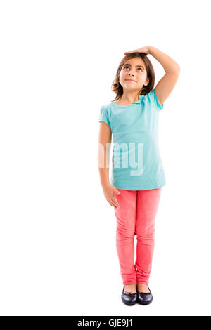 Little girl looking up and checking her size Stock Photo