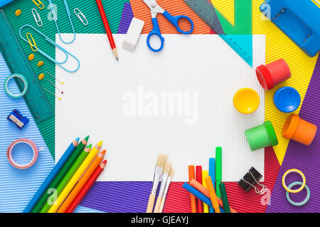 Multicolor composition of school supplies with blank paper on the center. Back to school. Flat lay Stock Photo