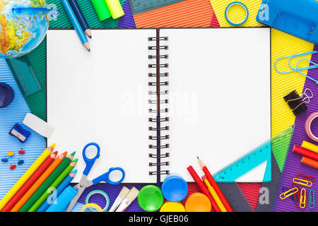 Back to school. Colorful composition of school supplies and blank notebook. Flat lay. Stock Photo