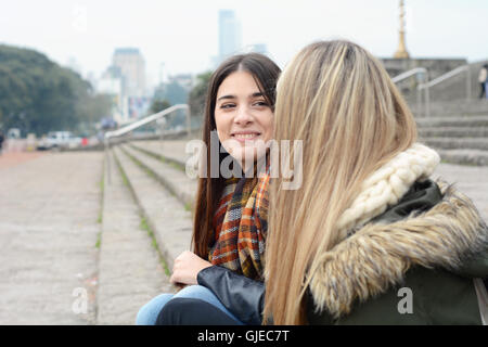 Portrait of two beautiful young friends having fun. Urban concept. Outdoors. Stock Photo