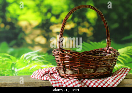 empty wicker basket and checkered plaid for picnic Stock Photo