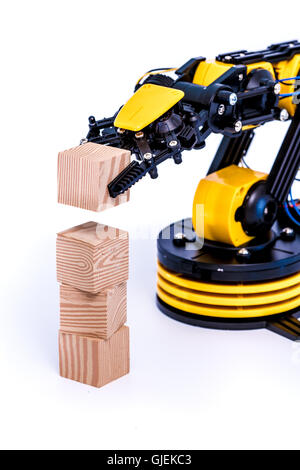 Plastic model of industrial robotics arm  Robot manipulator with toy cube Stock Photo