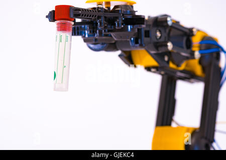 Plastic model of industrial robotics arm  Robot manipulator with sample test tube Stock Photo