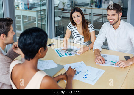 Group of young businesspeople discussing their working ideas in office Stock Photo