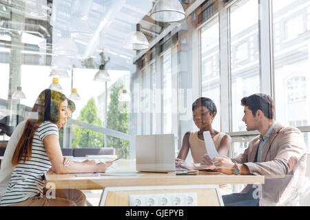 Group of young businesspeople using laptop on conference in office Stock Photo