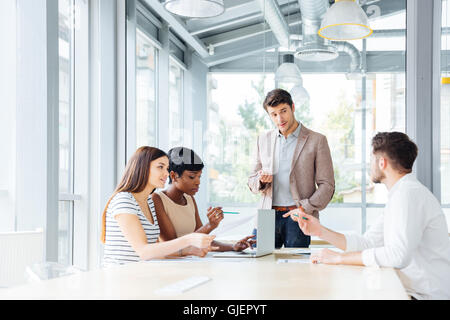Concentrated young businesspeople working and making new project in office together Stock Photo