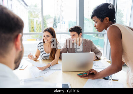 Group of young business people working with laptop tohether in office Stock Photo