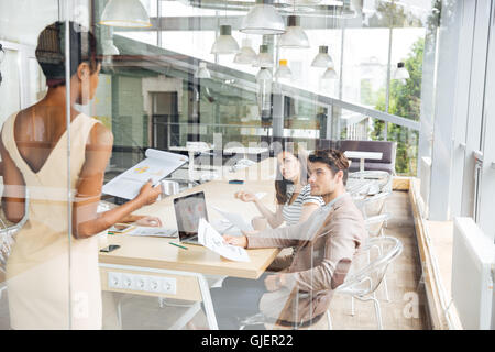 Group of young business people discussing new ideas in conference hall Stock Photo