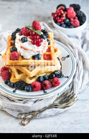 Belgium waffles with berry fruits and ice cream on top,selective focus Stock Photo