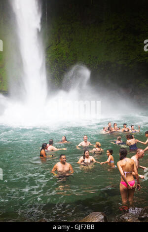 Tourists swimming in la Fortuna waterfall, La Fortuna, Arenal province, Costa Rica, Central America