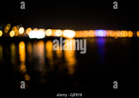 Bokeh of street light in the city with reflection on the river Stock Photo