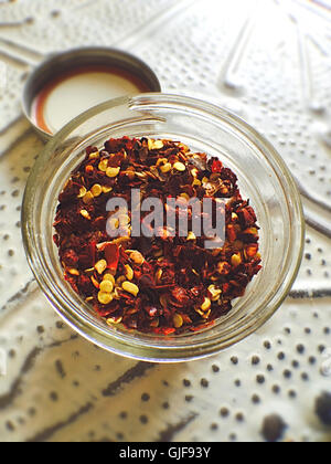 Still Life of Jar of Red Pepper Flakes Stock Photo