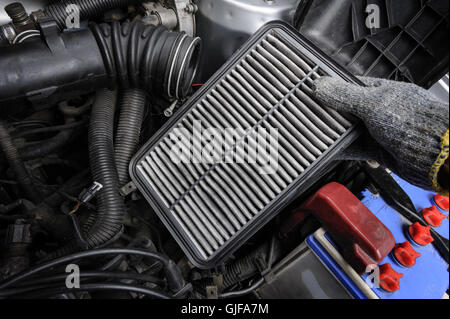 technician changing the air filter for car Stock Photo