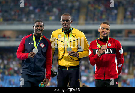 (left to right) USA's Justin Gatlin receives the silver medal, Jamaica's Usain Bolt receives the gold medal and Canada's Bronze Andre De Grasse receives the bronze medal for the Men's 100 Meters at the Olympic Stadium on the tenth day of the Rio Olympics Games, Brazil. Picture date: Monday August 15, 2016. Photo credit should read: Mike Egerton/PA Wire. EDITORIAL USE ONLY Stock Photo