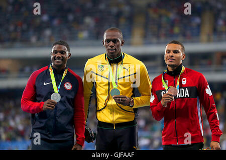 (left to right) USA's Justin Gatlin receives the silver medal, Jamaica's Usain Bolt receives the gold medal and Canada's Bronze Andre De Grasse receives the bronze medal for the Men's 100 Meters at the Olympic Stadium on the tenth day of the Rio Olympics Games, Brazil. Picture date: Monday August 15, 2016. Photo credit should read: Mike Egerton/PA Wire. EDITORIAL USE ONLY Stock Photo