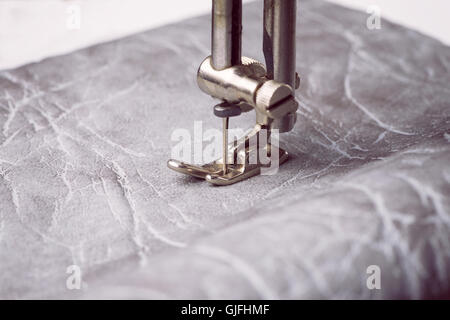 Sewing machine working part with leather closeup shot. Stock Photo