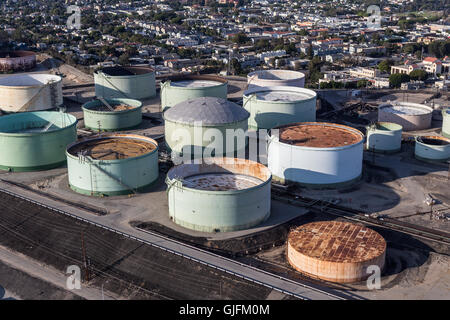 El Segundo, California, USA - August 6, 2016:  Afternoon aerial view of oil refinery storage tanks overlooking residential homes Stock Photo