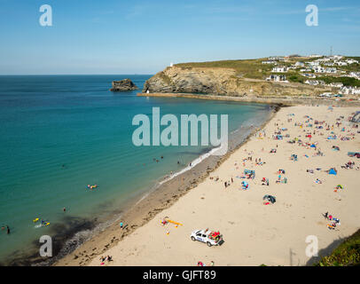 Portreath beach shore near high tide in Cornwall England. Looking down from a cliff top on a sunny summers day. Stock Photo