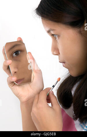 girl applying makeup Stock Photo