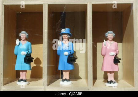 Animated waving HM Queen figures in souvenir shop window, London Stock Photo